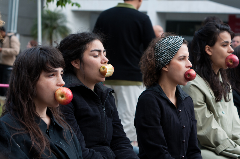 "Mulheres mordendo maçã, símbolo do fruto proibido". Foto de Andre M. Chang copyright Demotix (04/06/2011), São Paulo, Brasil.