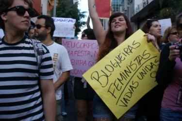 Nessa Guedes holds a Blogueiras Feministas (Feminist Bloggers) sign dring the SlutWalk in São Paulo