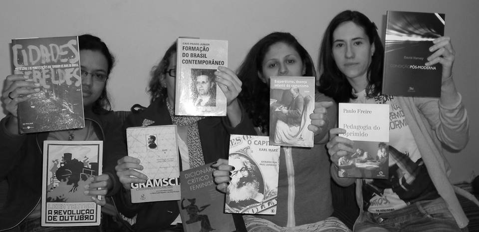 Group of young women pose with some "subversive" literary works in protest against seizures at the house of protesters by the police.